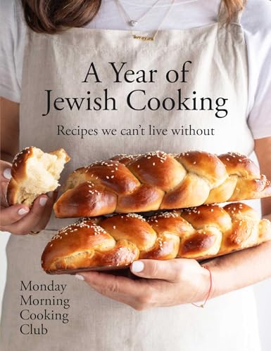 Cookbook cover featuring braided challah bread and hands holding a slice.