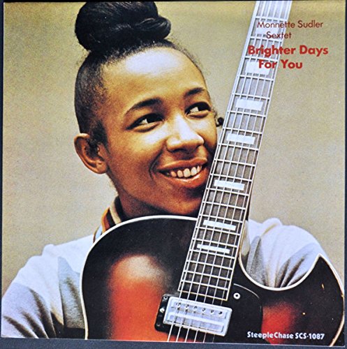Vinyl record cover featuring a smiling woman holding a guitar against a beige background.