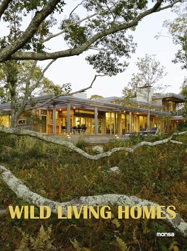 A modern house with large glass windows surrounded by trees and overgrown vegetation.