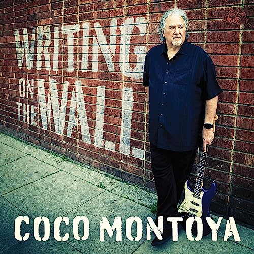 Coco Montoya album cover featuring a man with a guitar by a brick wall.