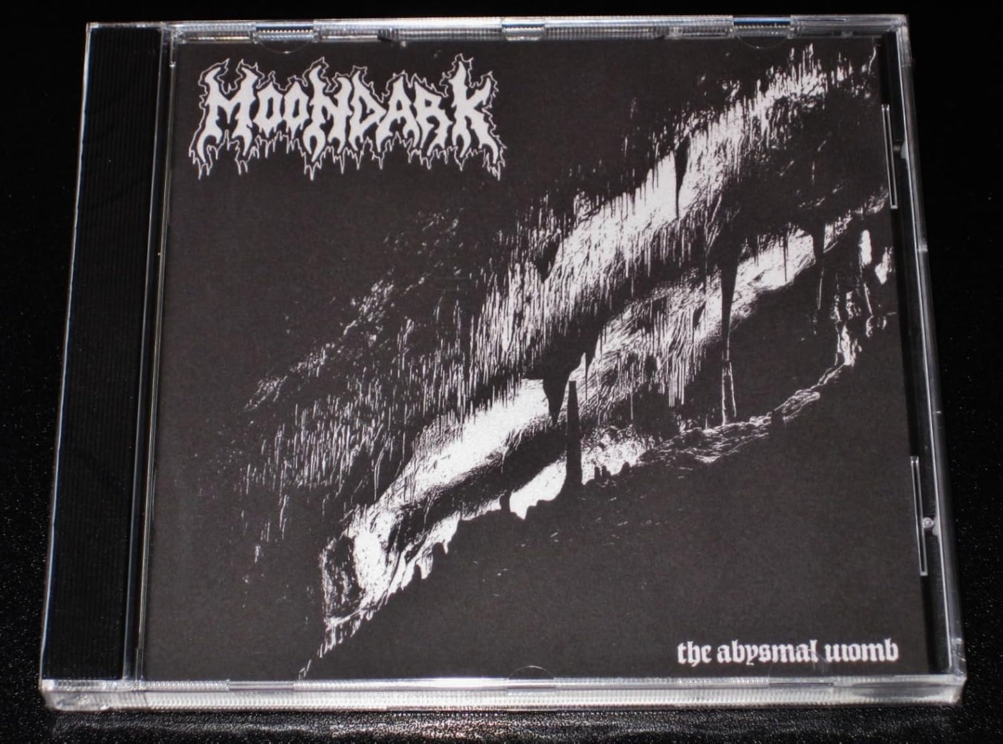 Black and white CD case for Moondark’s “The Abysmal Womb.”