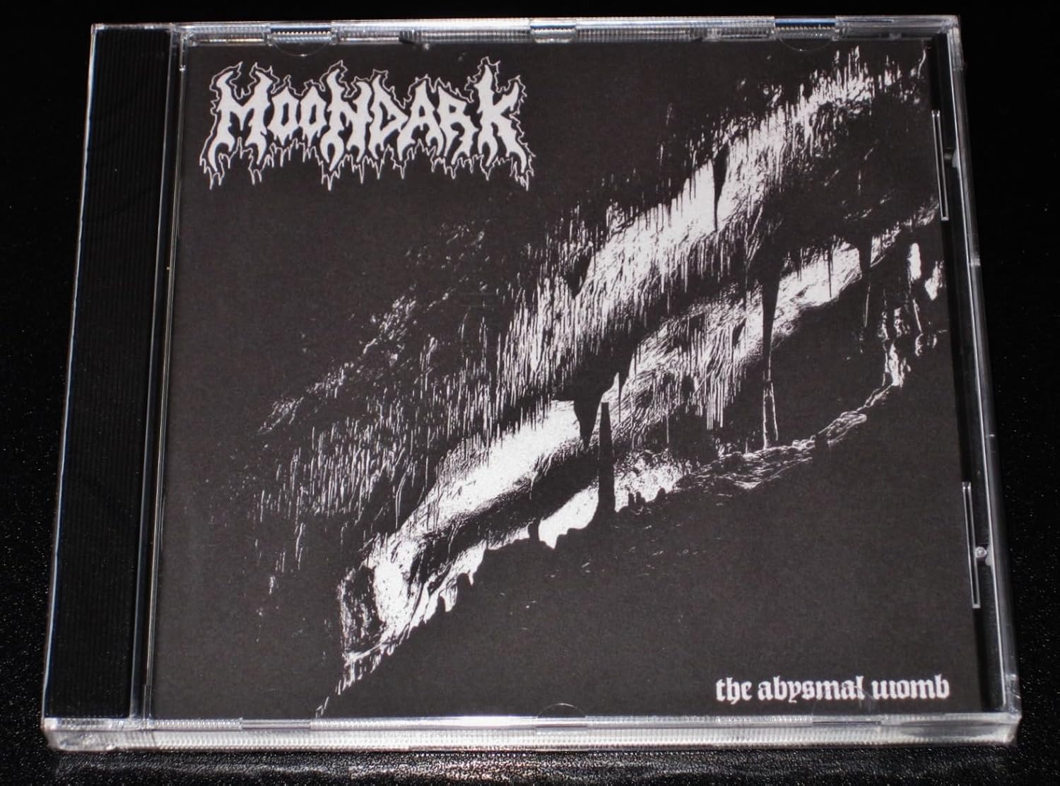 Black and white CD case for Moondark’s “The Abysmal Womb.”