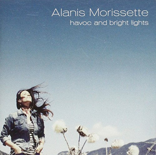 Alanis Morissette album cover, woman with windswept hair, blue sky.