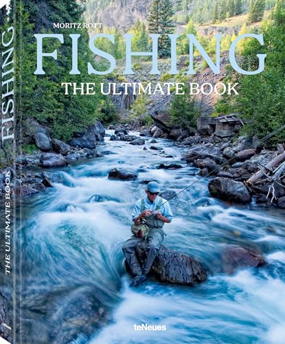 A fly fisherman sits on a rock in a rushing mountain river.