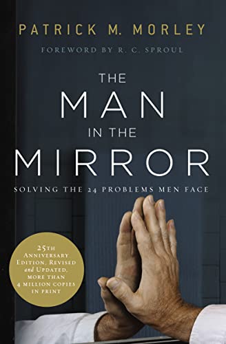 Book cover showing a man's hands pressed against a mirror with title text above.