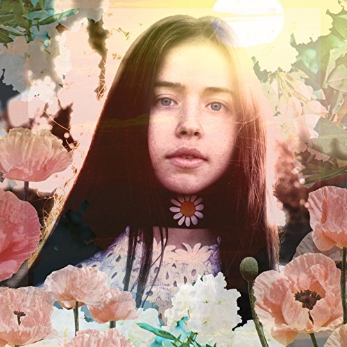 "Album cover featuring a woman surrounded by flowers with a sunny background."