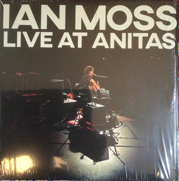 Ian Moss album cover: live performance photo in dark lighting.