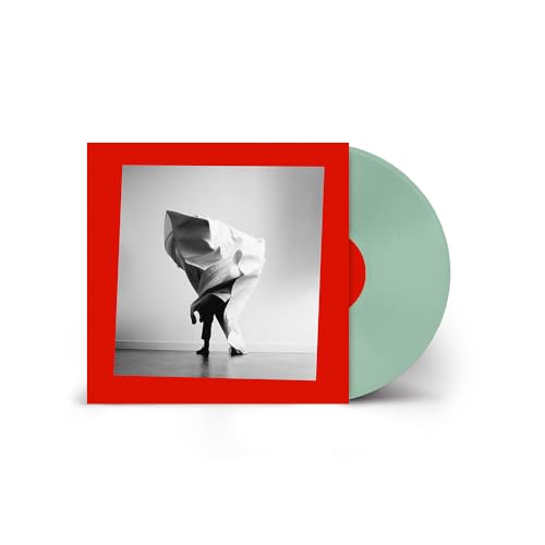 Vinyl record with red cover featuring a figure draped in white fabric.