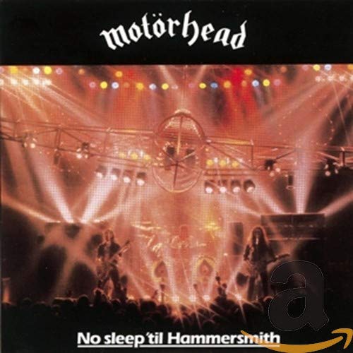 Motörhead concert stage with band members performing under bright lights, album cover art.