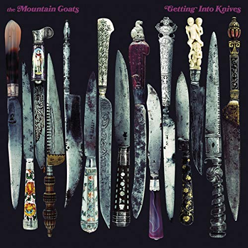 A collection of antique knives with ornate handles arranged vertically against a black background.
