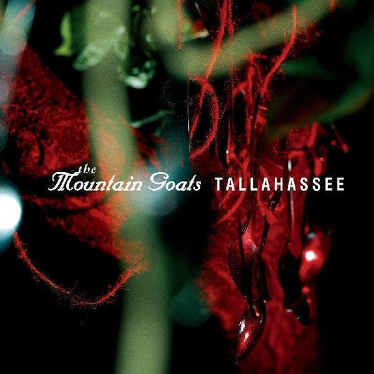 CD cover for The Mountain Goats’ “Tallahassee” with red, blurred foliage.