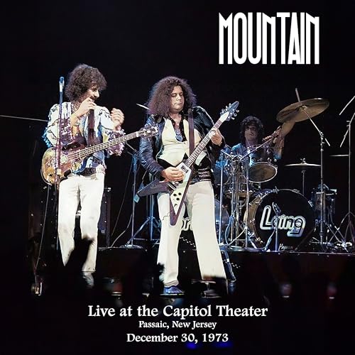 1973 concert photo of Mountain band members playing instruments onstage.