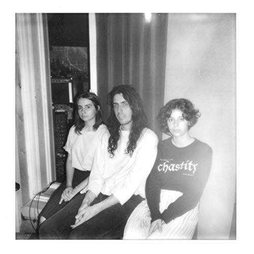 Black and white photo of three people seated indoors.