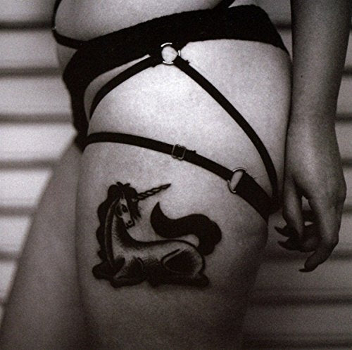 Black and white CD cover with a unicorn tattoo on a thigh.