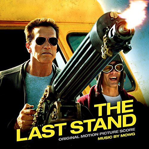 Arnold Schwarzenegger and a man in goggles firing a large machine gun.