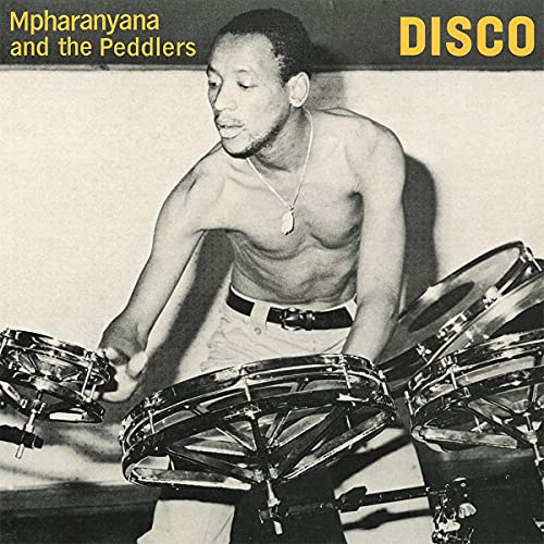 Black and white photo of a man playing timbales, album cover.