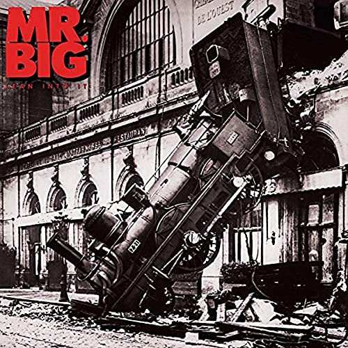 Album cover: a steam locomotive crashing through a building facade.