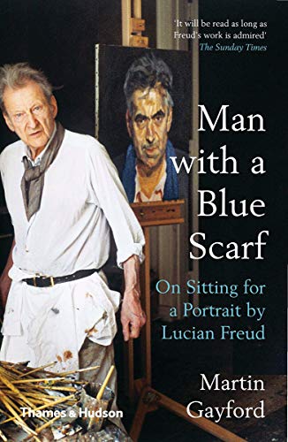 Martin Gayford stands beside a portrait of himself painted by artist Lucian Freud.