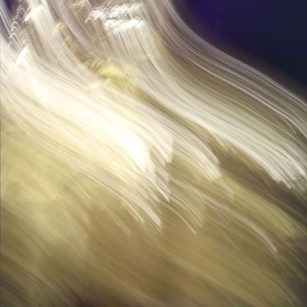Abstract, blurred image with flowing white and gold lines.