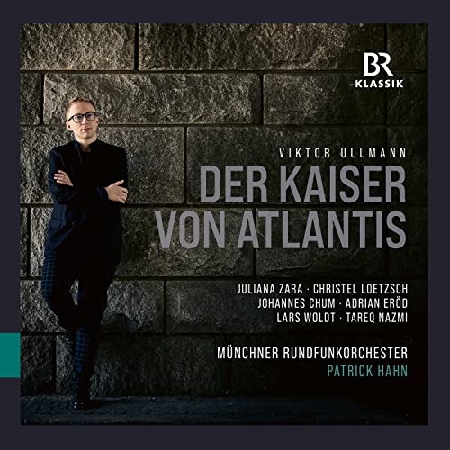 CD cover featuring a man in a suit against a dark stone wall.