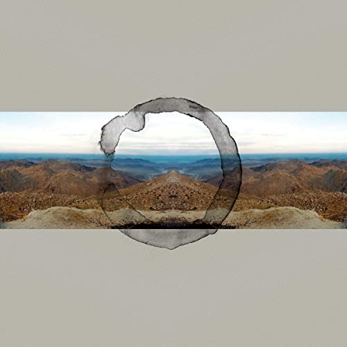 Album cover for Murcof’s “Martes + Utopia” featuring mountains and a circular mark.