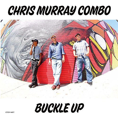 Three men stand against a colorful graffiti wall under the text Chris Murray Combo.