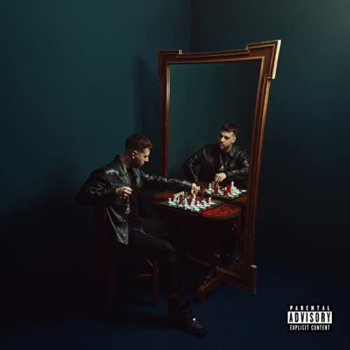 Man in leather jacket playing chess with his reflection in a mirror.