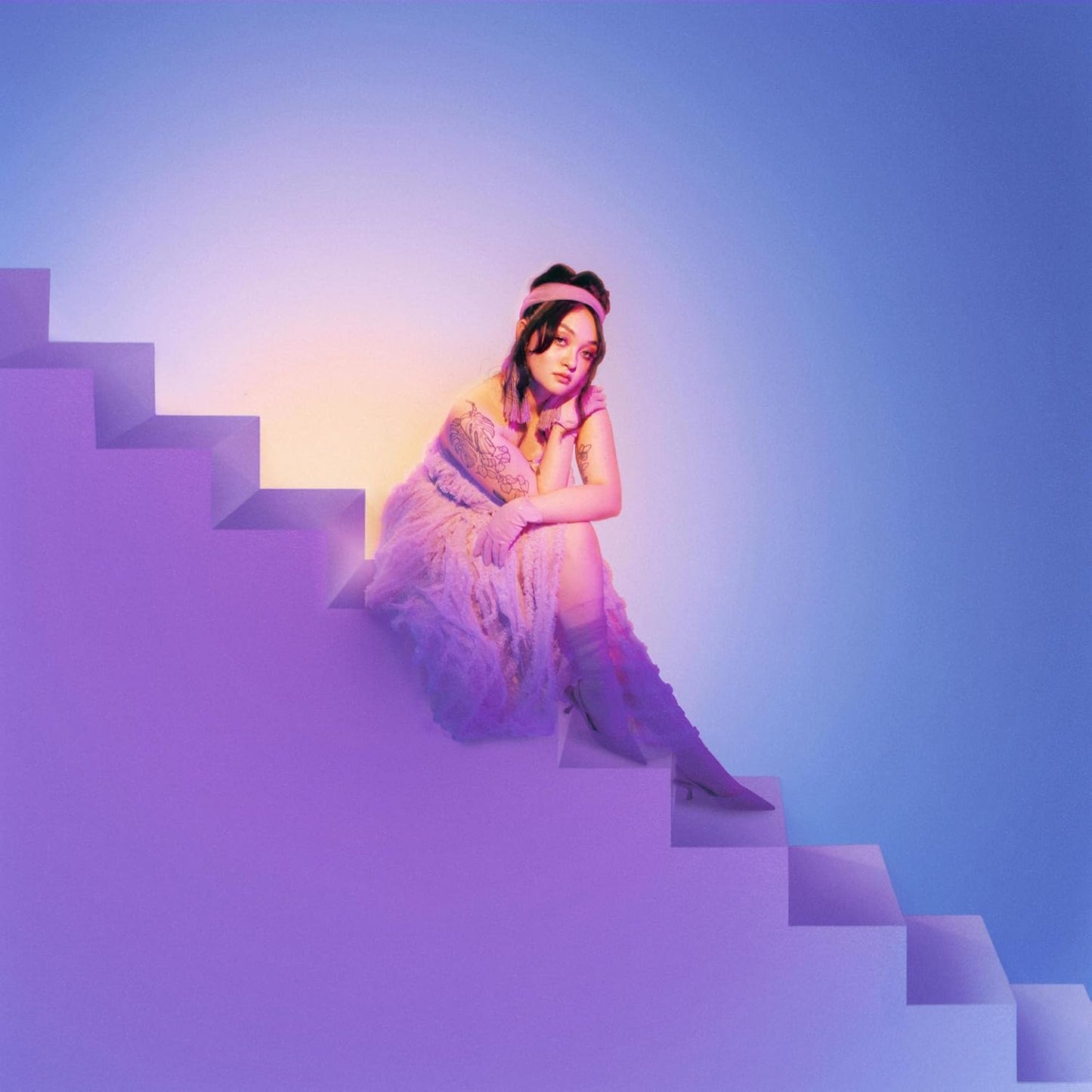 A square vinyl record jacket featuring a portrait of Mxmtoon against a blue background.