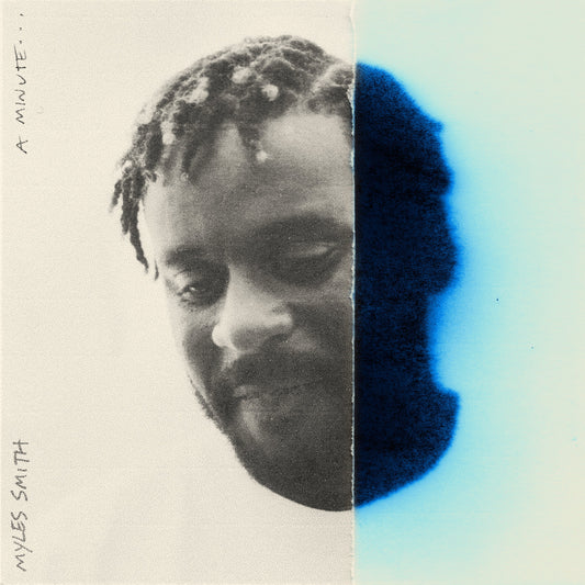 Black and white portrait of Myles Smith with blue color block.