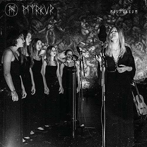 Black and white album cover featuring a singer and choir at microphones.