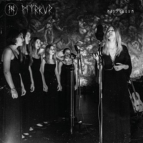 Black and white album cover featuring a woman singing with a choir.