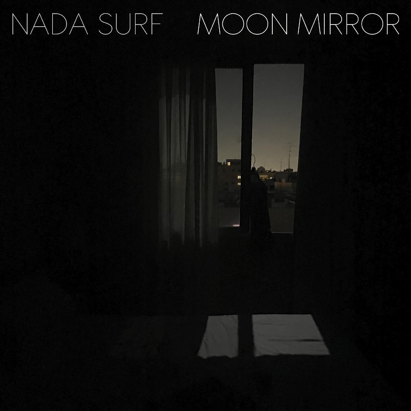 Dark album cover with a window view and text “Moon Mirror” and “Nada Surf”.