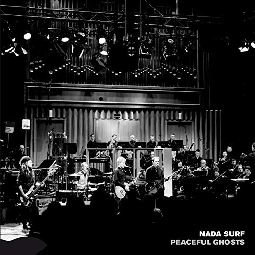 Black and white image of Nada Surf performing with an orchestra onstage.