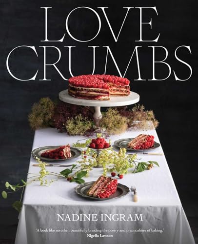 Book cover featuring a raspberry tart and floral arrangements on a table.