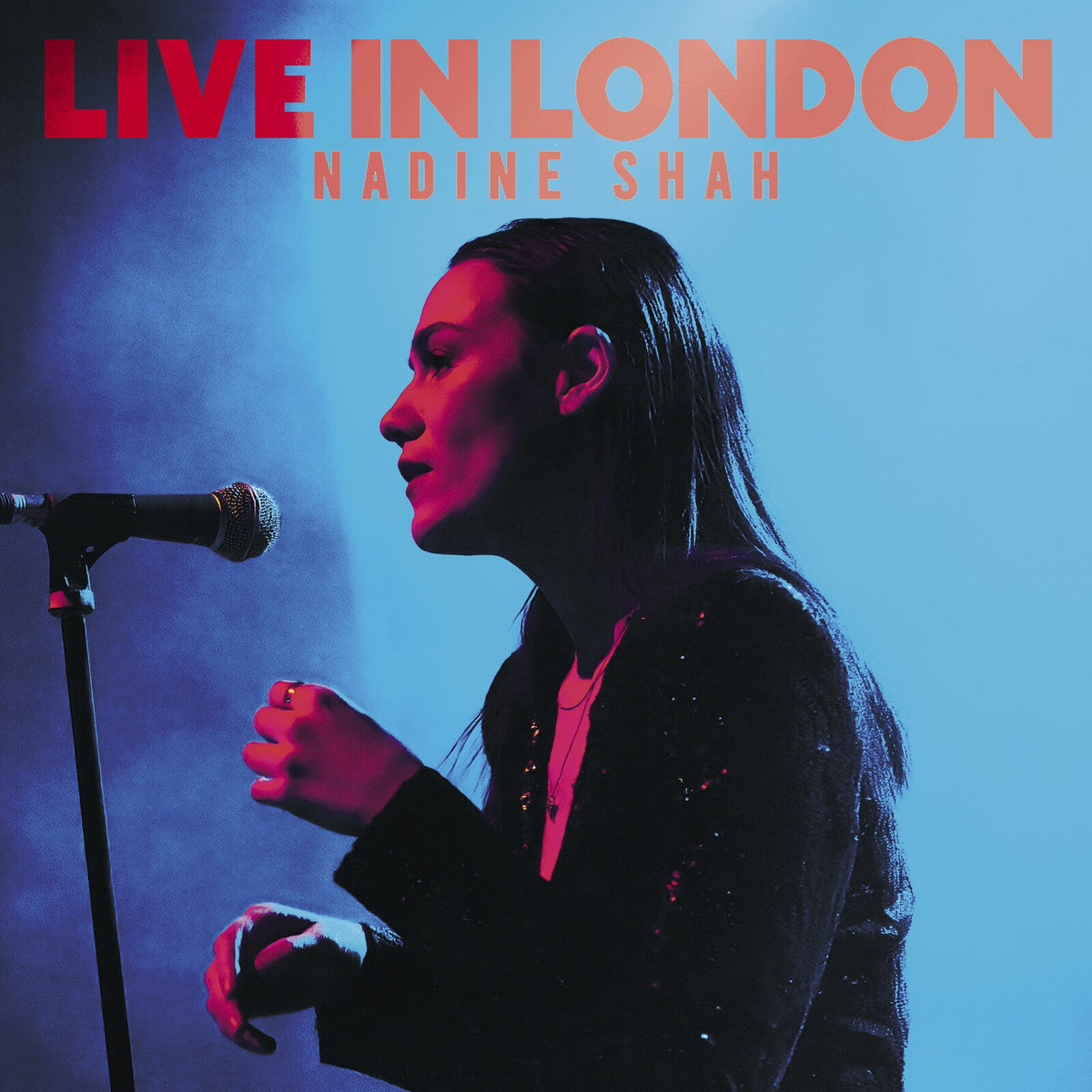 Nadine Shah album cover, singer at a microphone, red and blue tones.