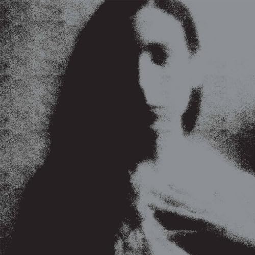 High-contrast, grainy black and grey portrait of a woman with long dark hair.