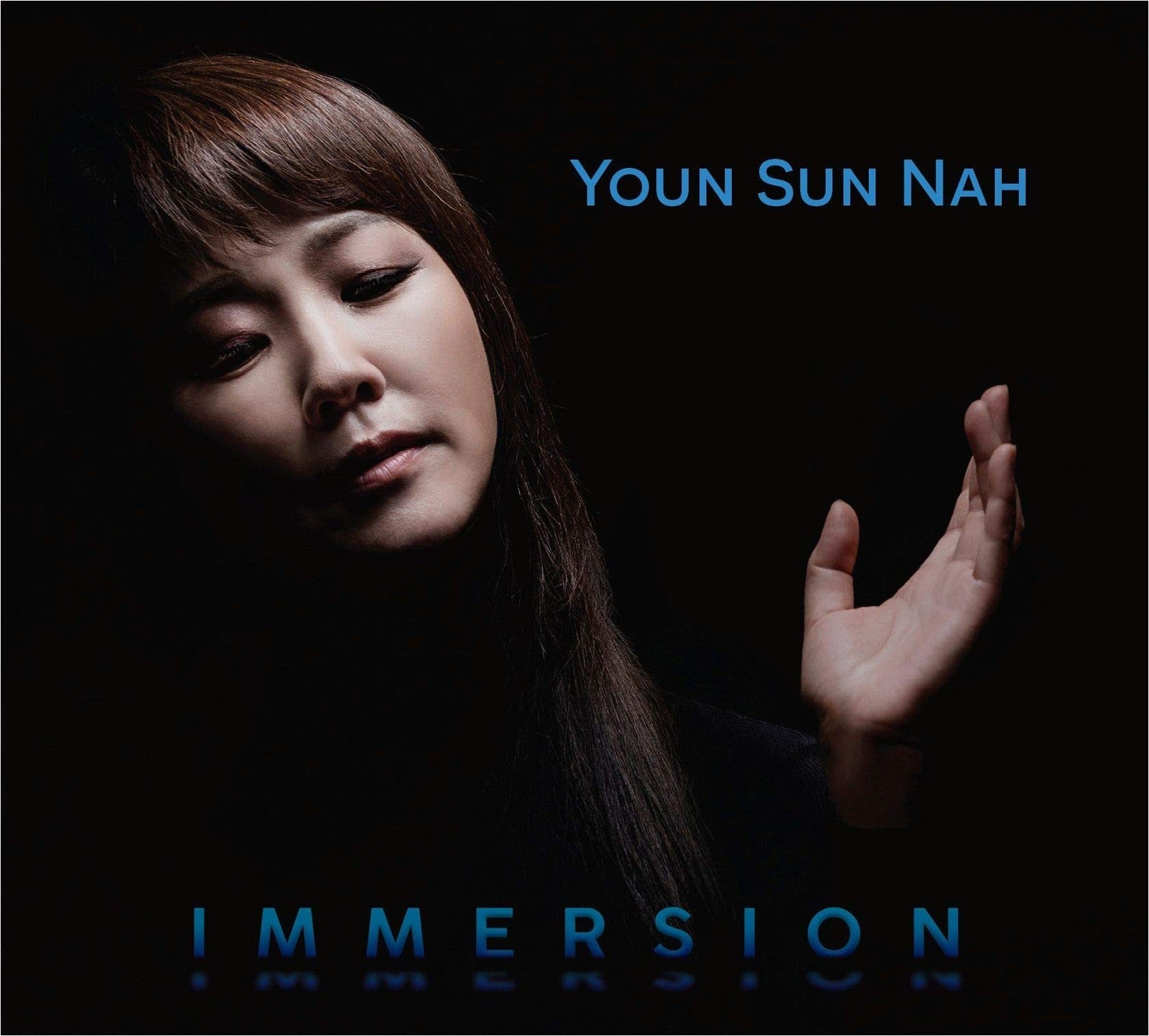 Album cover featuring a portrait of Youn Sun Nah, dark blue background.