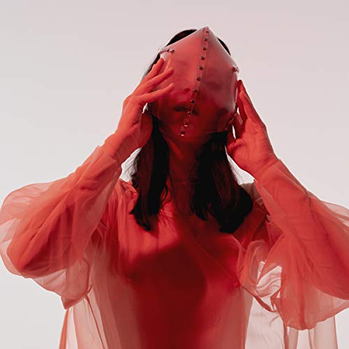 Person in red clothing and mask, face obscured, looking upwards.