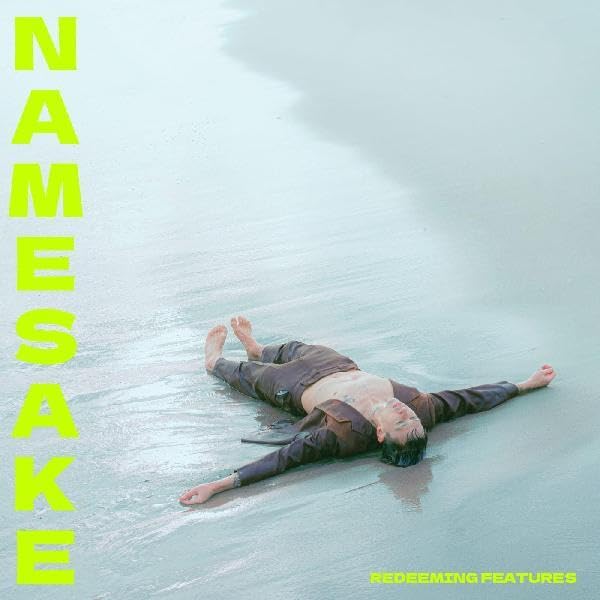 Person lying on their back on a wet beach with neon yellow text overlay.