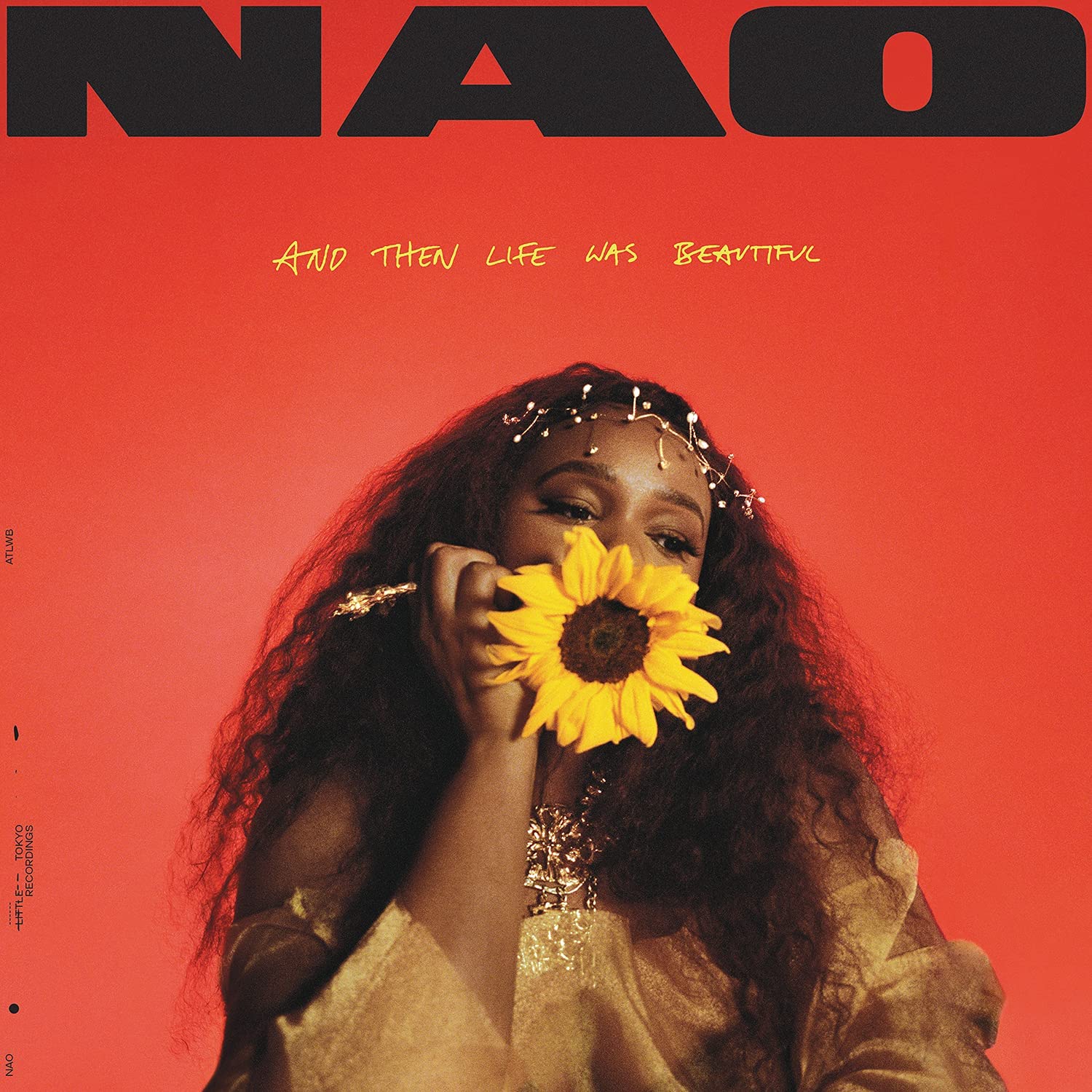 Nao album cover: woman holding a sunflower against a red background.