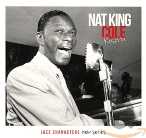 Black and white portrait of Nat King Cole singing into a vintage microphone.