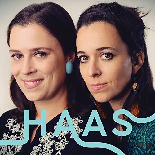 Two women with dark hair and the word "HAAS" in blue text.