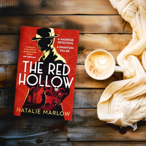 Book cover with a detective, coffee cup, and knitted blanket on wood.