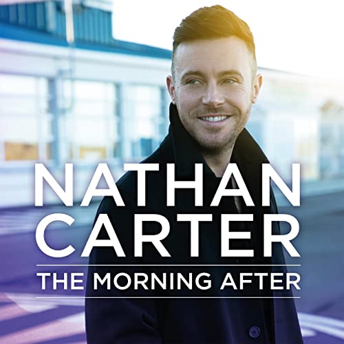 Nathan Carter smiling, wearing a dark coat, with album title text overlaid on image.