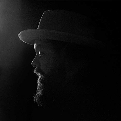 Black and white portrait of a man with a beard and hat.