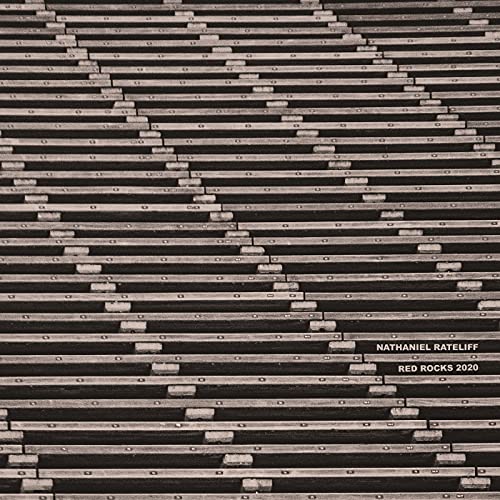 Black and white image of empty bleacher seats with text in the corner.