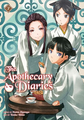 Three young women in traditional robes sit at a table on a patterned background.