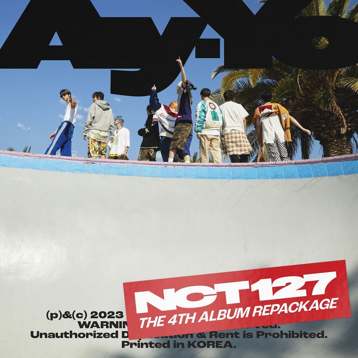 K-pop group NCT 127 album cover with eight members standing on a wall.