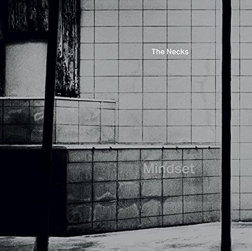 Black and white album cover for "The Necks - Mindset" with tiled wall.