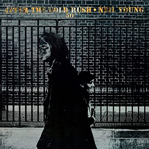 Neil Young album cover featuring a silhouetted figure walking before a brick wall.